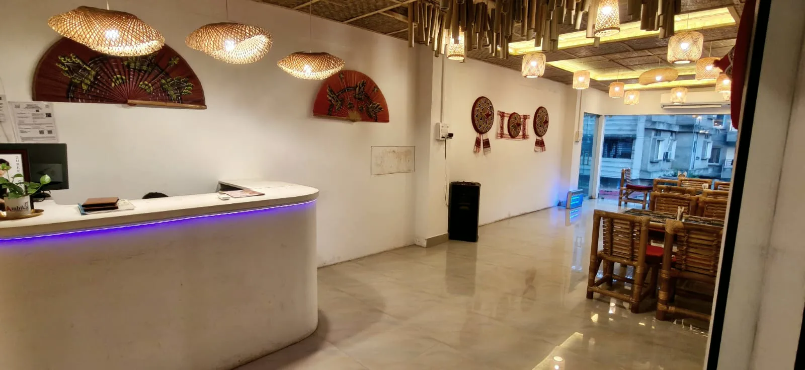Reception counter with bamboo lamps and red fan art